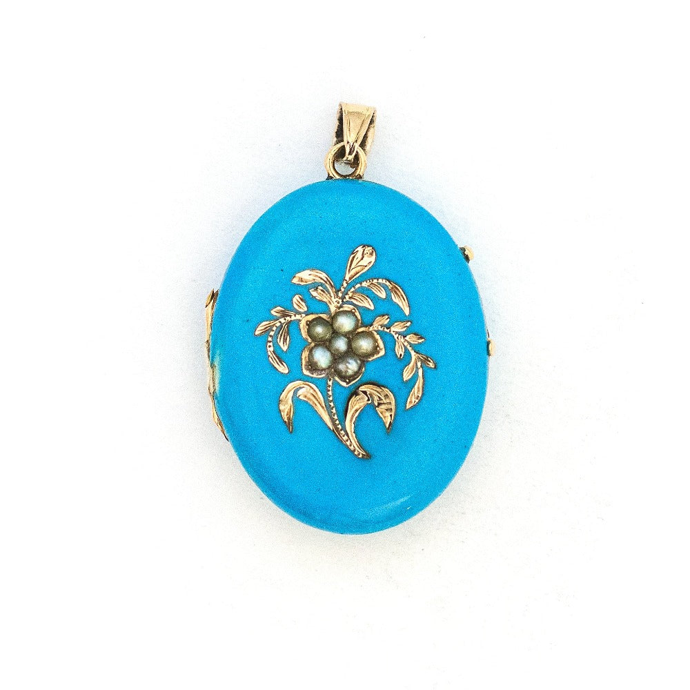 This 14K gold oval locket features pearls at the center of an intricate forget-me-not flower with a rich robin egg blue enamel background. It opens to hold two photos, includes one original frame and pairs perfectly with one of our antique 14K gold chains. Front Locket View