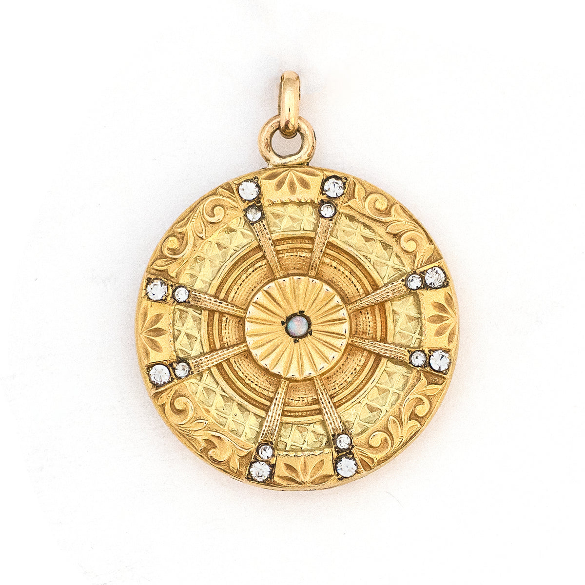 This striking round locket features an opal at it's center with intricate multi layered details and white paste stones radiating out in a sun-like pattern. It opens to hold two photos and pairs perfectly with one of our antique gold fill chains, front locket view