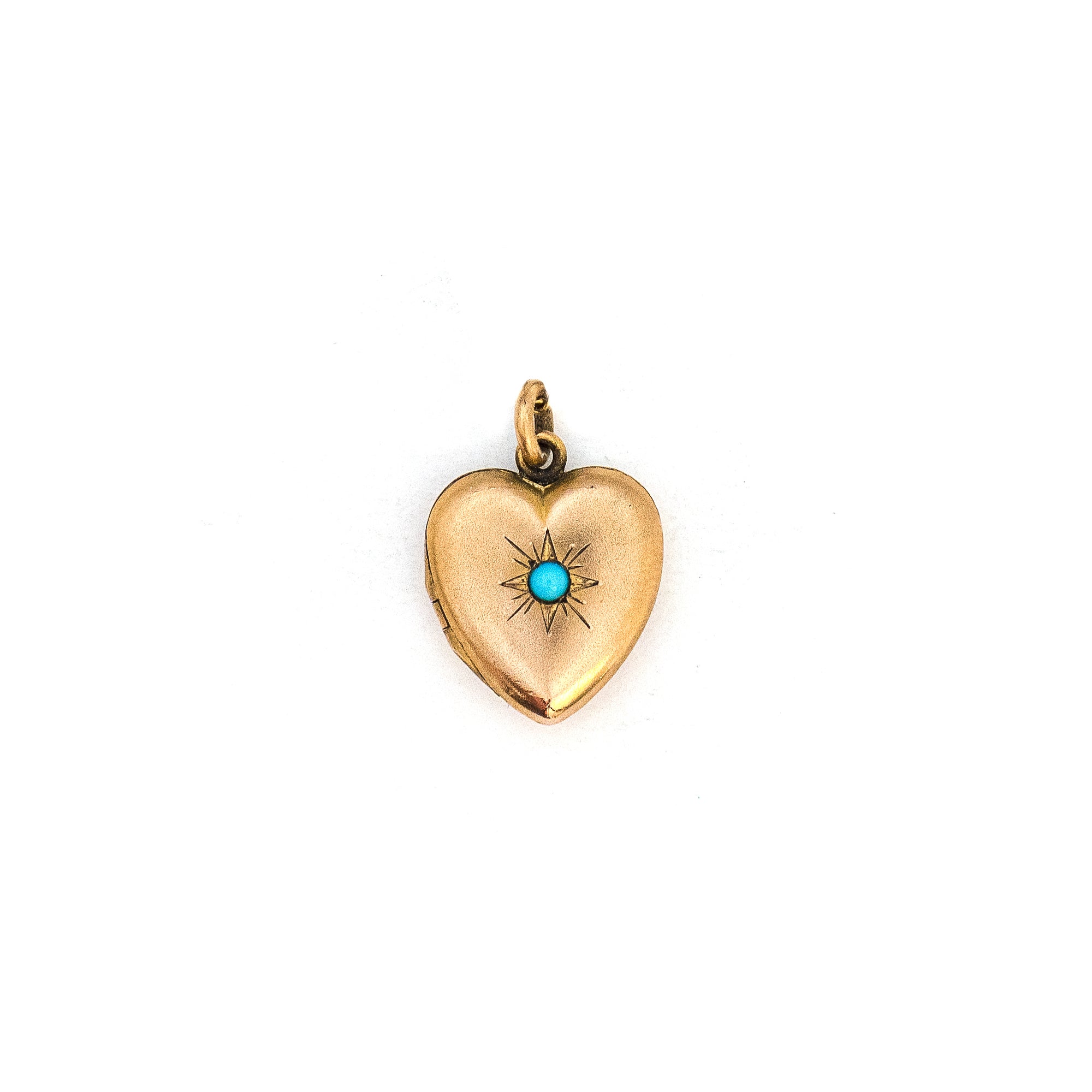 This petite heart shaped locket features a classic Victorian starburst with turquoise at it's center. It opens to hold two photos, includes both original frames and pairs perfectly with one of our antique gold fill chains.  Front locket view