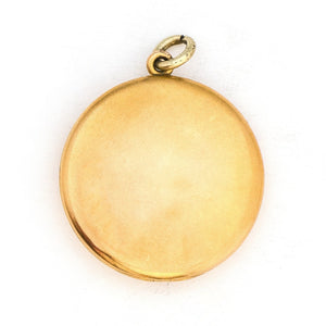 This large round locket features a classic Victorian starburst with a 3.5 mm white paste stone at the center. It opens to hold two photos, includes both original frames and pairs perfectly with one of our antique gold fill chains. Back Locket view