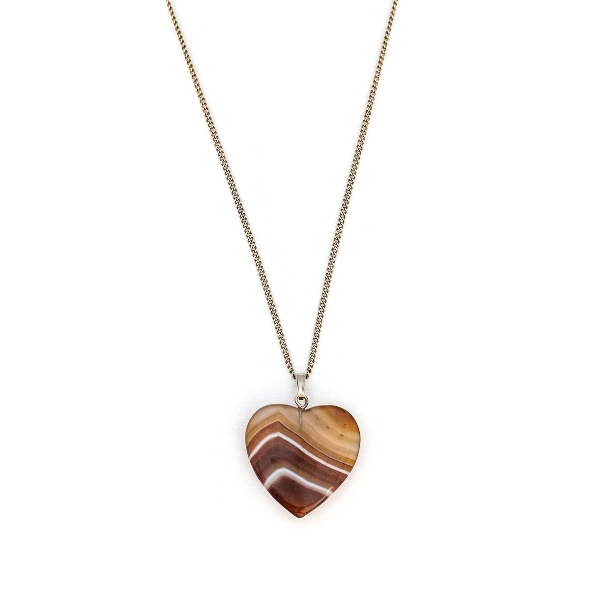 This sweet heart shaped charm is made of red and white banded translucent agate, a gemstone said to be soothing and calming to the wearer. Paired with one of our antique silver chains, this heart charm can be worn both alone as a pendant or in a cluster of charms. Front of charm