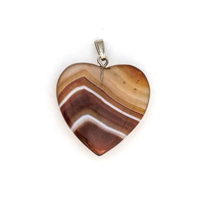 This sweet heart shaped charm is made of red and white banded translucent agate, a gemstone said to be soothing and calming to the wearer. Paired with one of our antique silver chains, this heart charm can be worn both alone as a pendant or in a cluster of charms. Front of charm