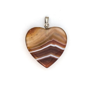 This sweet heart shaped charm is made of red and white banded translucent agate, a gemstone said to be soothing and calming to the wearer. Paired with one of our antique silver chains, this heart charm can be worn both alone as a pendant or in a cluster of charms. Back of charm