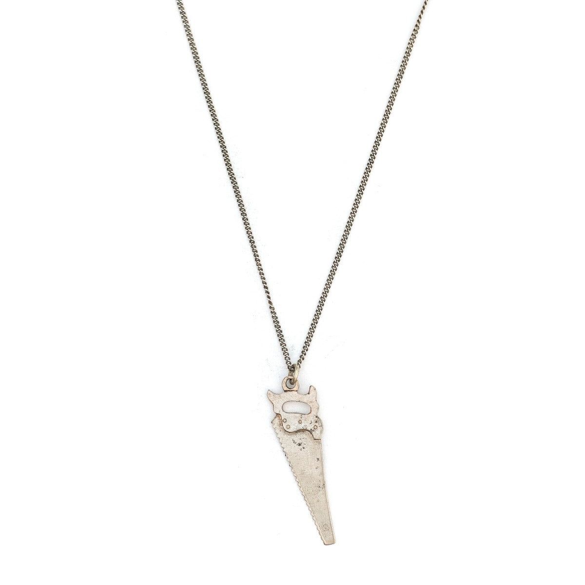 This unique saw charm is made of sterling silver and features intricate realistic details and the E.C. ATKINS & Co. Maker Mark, a prominent saw manufacturer out of Cleveland, OH, established in 1855. Paired with one of our antique silver chains, this saw charm can be worn both as a pendant or in a cluster of charms. Front Charm view, shown on chain