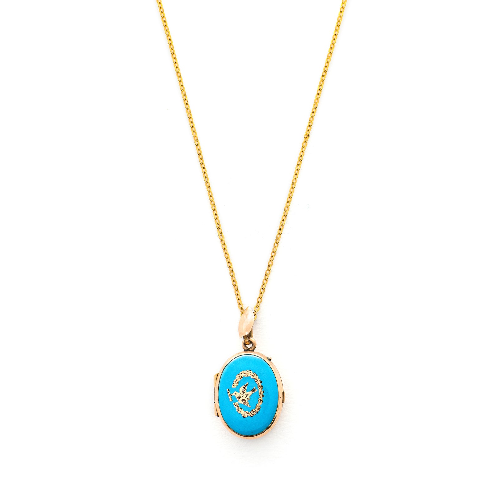 This absolutely gorgeous robin egg blue enamel and gold fill locket is oval shaped and features a sparrow carrying a scroll in it's beak. The sparrow is surrounded by an intricate golden wreath. It opens to hold two photos, includes both original frames and glass, and pairs perfectly with one of our antique gold fill chains.  Front Locket View