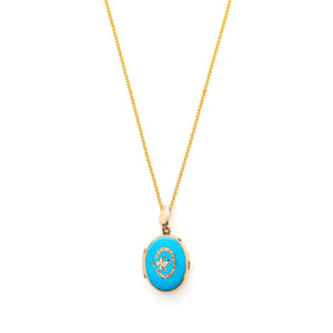 This absolutely gorgeous robin egg blue enamel and gold fill locket is oval shaped and features a sparrow carrying a scroll in it's beak. The sparrow is surrounded by an intricate golden wreath. It opens to hold two photos, includes both original frames and glass, and pairs perfectly with one of our antique gold fill chains.  Front Locket View, shown on chain