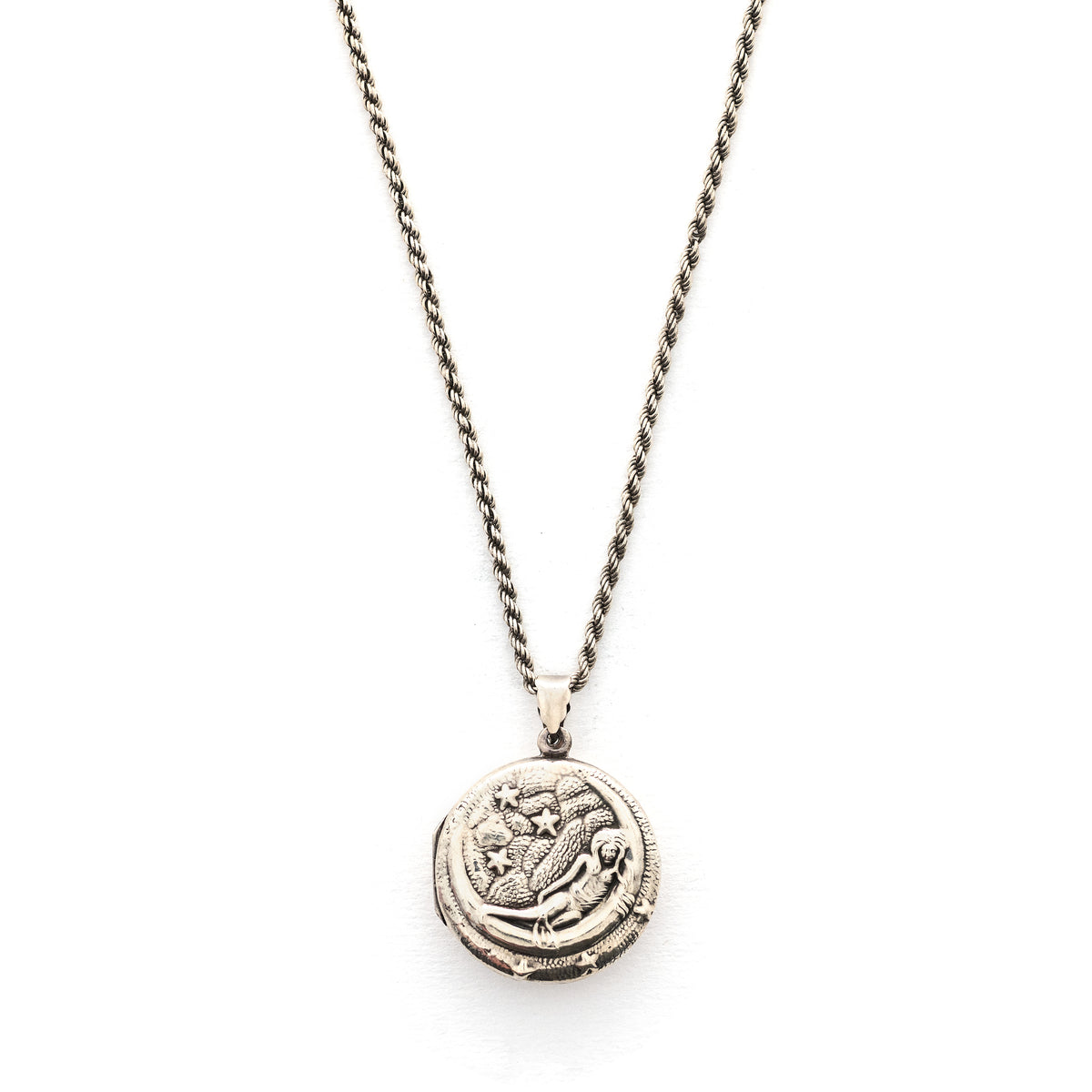 This round sterling silver Victorian locket features a woman lying in a crescent moon surrounded by stars. It opens to hold two photos and pairs perfectly with one of our antique sterling silver chains.  Front locket view shown on chain