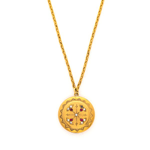 This incredibly unique gold fill locket features red and white paste stones surrounding a central starburst. This locket has two compartments: one that holds a photo, original frame included, and a second secret compartment that holds a tiny sachet. The inscribed text inside the locket tells us this design was patent pending (See photos).  We've never seen anything like it! This gem pairs perfectly with one of our antique gold fill chains.  Front locket view shown on chain