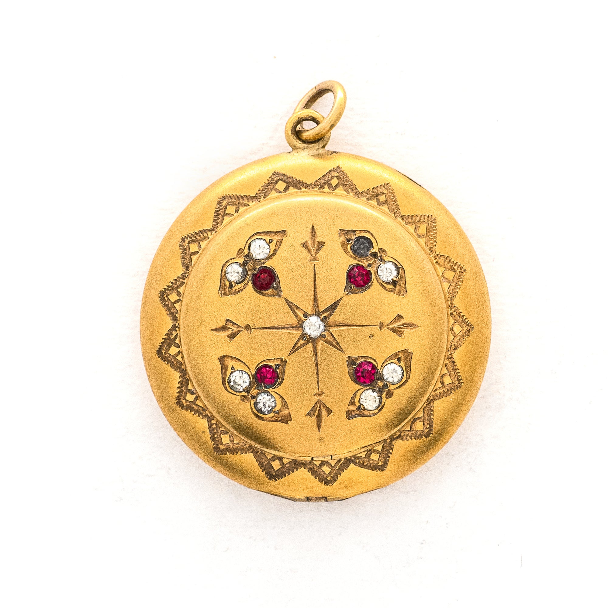 This incredibly unique gold fill locket features red and white paste stones surrounding a central starburst. This locket has two compartments: one that holds a photo, original frame included, and a second secret compartment that holds a tiny sachet. The inscribed text inside the locket tells us this design was patent pending (See photos).  We've never seen anything like it! This gem pairs perfectly with one of our antique gold fill chains.  Front locket view
