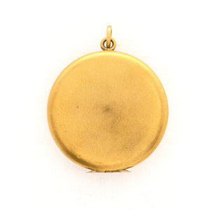 This incredibly unique gold fill locket features red and white paste stones surrounding a central starburst. This locket has two compartments: one that holds a photo, original frame included, and a second secret compartment that holds a tiny sachet. The inscribed text inside the locket tells us this design was patent pending (See photos).  We've never seen anything like it! This gem pairs perfectly with one of our antique gold fill chains.  Back locket view
