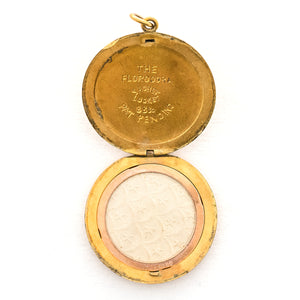 This incredibly unique gold fill locket features red and white paste stones surrounding a central starburst. This locket has two compartments: one that holds a photo, original frame included, and a second secret compartment that holds a tiny sachet. The inscribed text inside the locket tells us this design was patent pending (See photos).  We've never seen anything like it! This gem pairs perfectly with one of our antique gold fill chains.  Open locket, showing picture frame