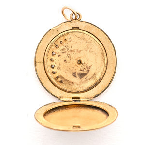 This classic Victorian locket features a large crescent moon surrounding a bright starburst with 10 white Victorian paste stones throughout the design. It opens to hold two photos, includes one original frame and pairs perfectly with one of our antique gold fill chains.  Open locket view