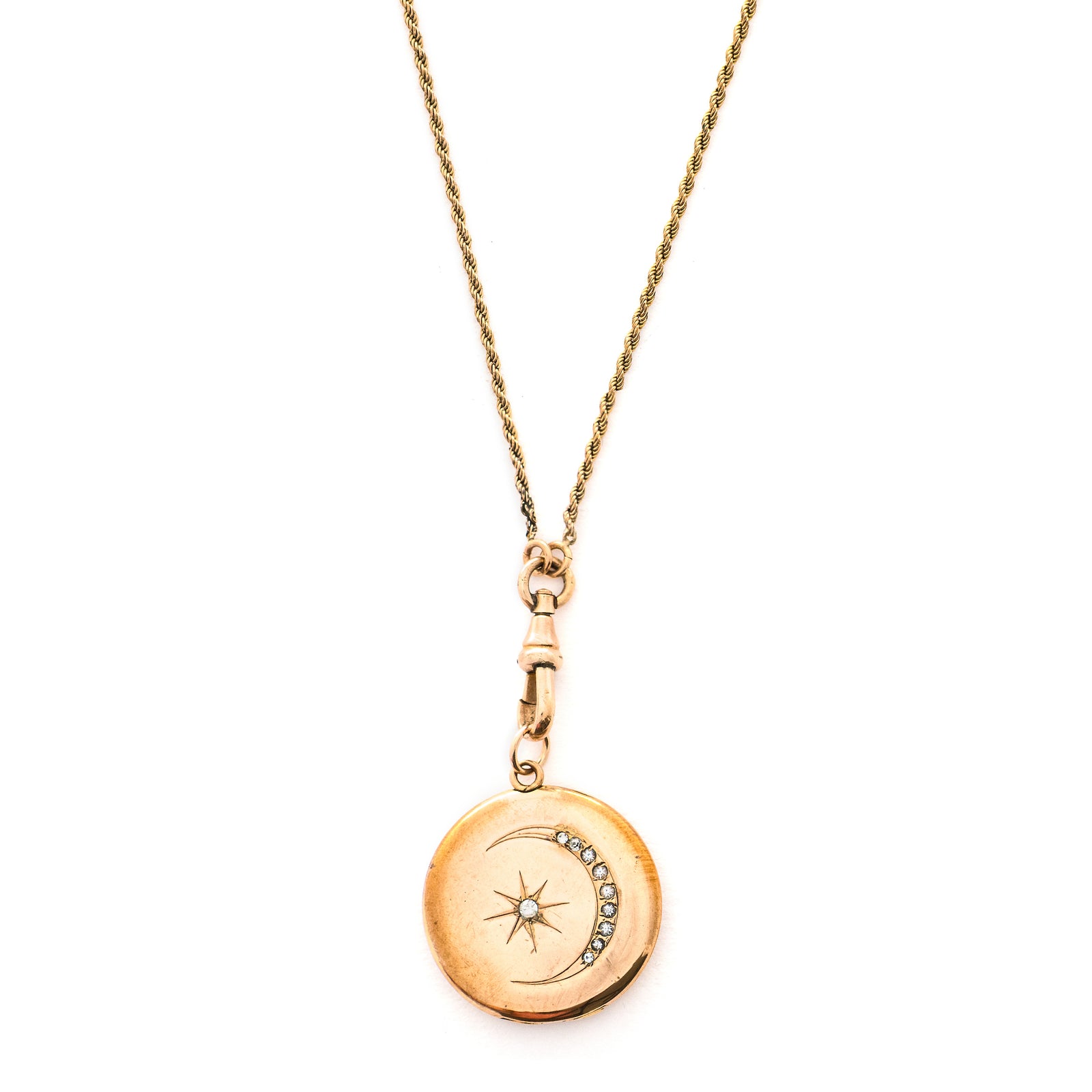 This classic Victorian locket features a large crescent moon surrounding a bright starburst with 10 white Victorian paste stones throughout the design. It opens to hold two photos, includes one original frame and pairs perfectly with one of our antique gold fill chains.  Front locket view
