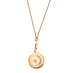 This classic Victorian locket features a large crescent moon surrounding a bright starburst with 10 white Victorian paste stones throughout the design. It opens to hold two photos, includes one original frame and pairs perfectly with one of our antique gold fill chains.  Front locket view, shown on chain