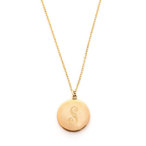 This round, matte locket features an ornate "S" in Victorian era script on the front and the initials MLC on the back. It opens to hold two photos, includes both original frames and pairs perfectly with one of our antique gold fill chains. Front locket view, shown on chain
