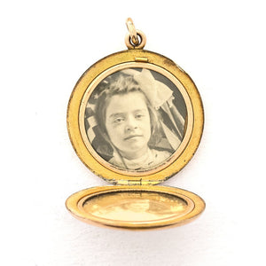 This round, matte locket features an ornate "S" in Victorian era script on the front and the initials MLC on the back. It opens to hold two photos, includes both original frames and pairs perfectly with one of our antique gold fill chains. Open locket view  