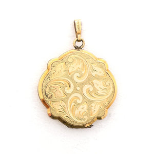 This uniquely shaped circular locket features a delicately etched curlicue design on front and back. It opens to hold two photos, includes one original frame and pairs perfectly with one of our antique gold fill chains. Locket back view