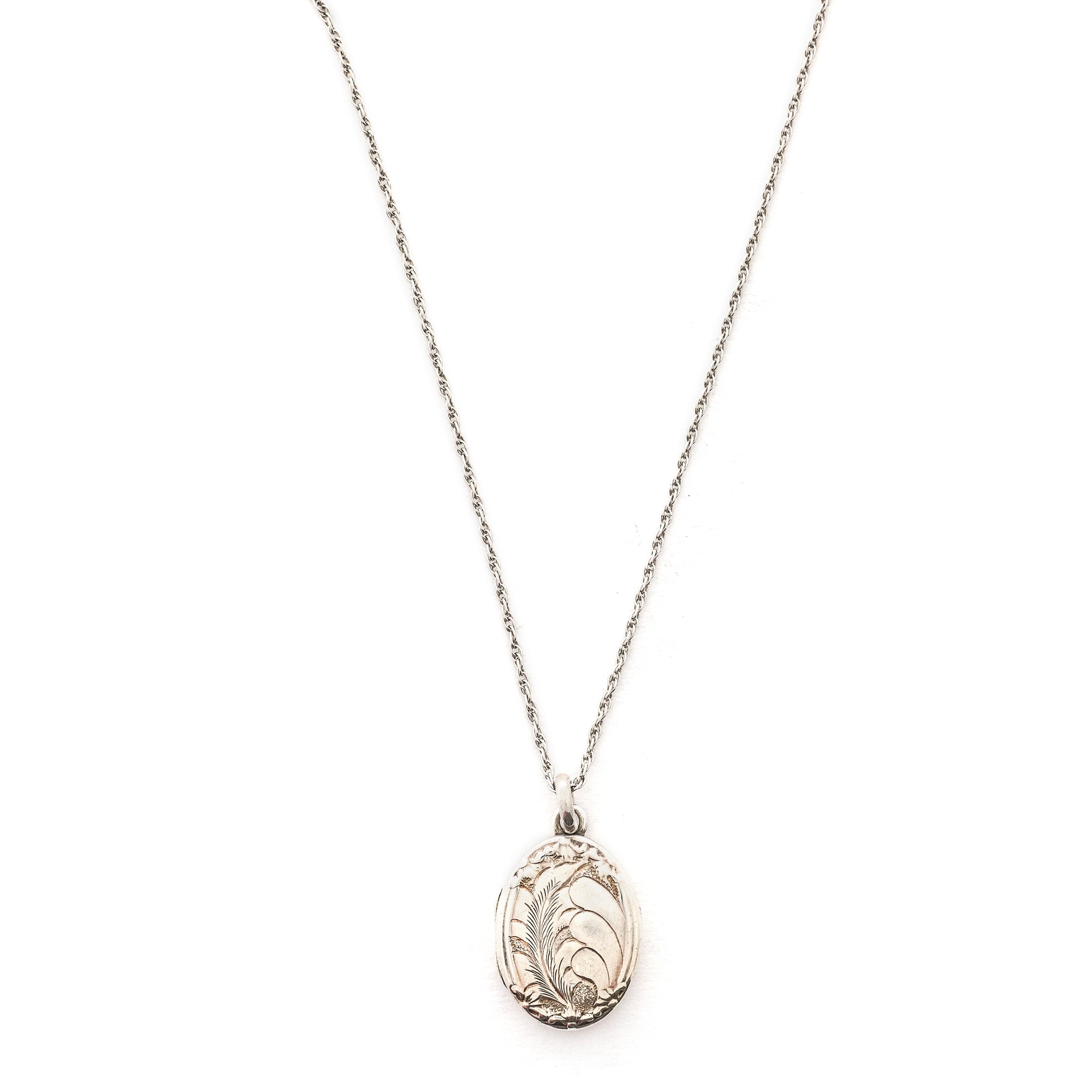 This oval sterling silver locket features two beautiful plumes with tiny flowers at it's base. It opens to hold two photos and pairs perfectly with one of our vintage sterling silver chains. Front locket view