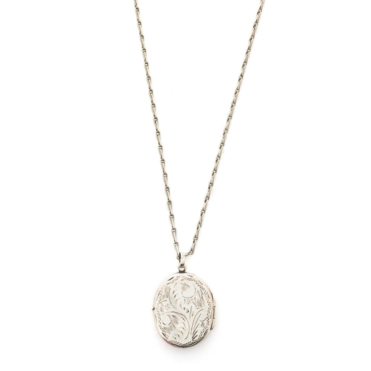 This oval sterling silver locket features a whimsical paisley pattern across the front and half of the back. It opens to hold two photos and pairs perfectly with one of our vintage sterling silver chains. Front Locket View shown on chain