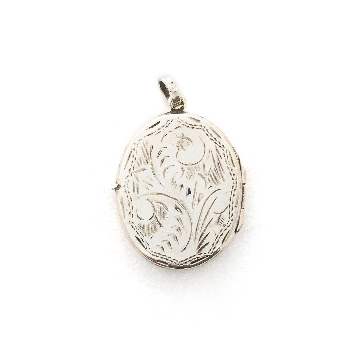 This oval sterling silver locket features a whimsical paisley pattern across the front and half of the back. It opens to hold two photos and pairs perfectly with one of our vintage sterling silver chains. Front Locket View