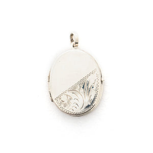 This oval sterling silver locket features a whimsical paisley pattern across the front and half of the back. It opens to hold two photos and pairs perfectly with one of our vintage sterling silver chains. Back locket View