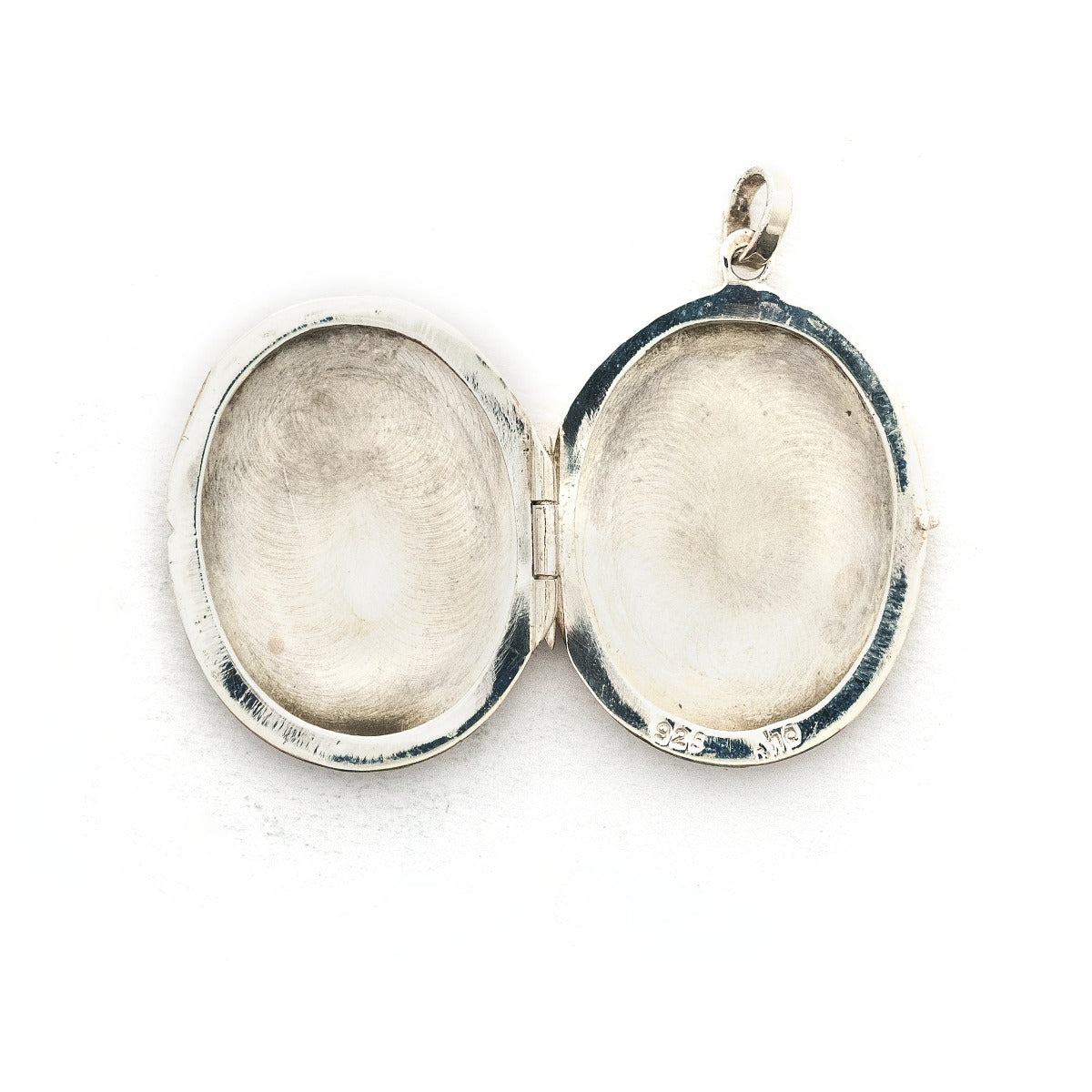 This oval sterling silver locket features a whimsical paisley pattern across the front and half of the back. It opens to hold two photos and pairs perfectly with one of our vintage sterling silver chains. Open Locket View