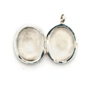 This oval sterling silver locket features a whimsical paisley pattern across the front and half of the back. It opens to hold two photos and pairs perfectly with one of our vintage sterling silver chains. Open Locket View