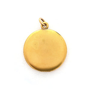 This classic round locket features a simple Victorian starburst with a white paste stone at it's center. It opens to hold two photos, includes one original frame and pairs perfectly with one of our antique gold fill chains. Back locket view