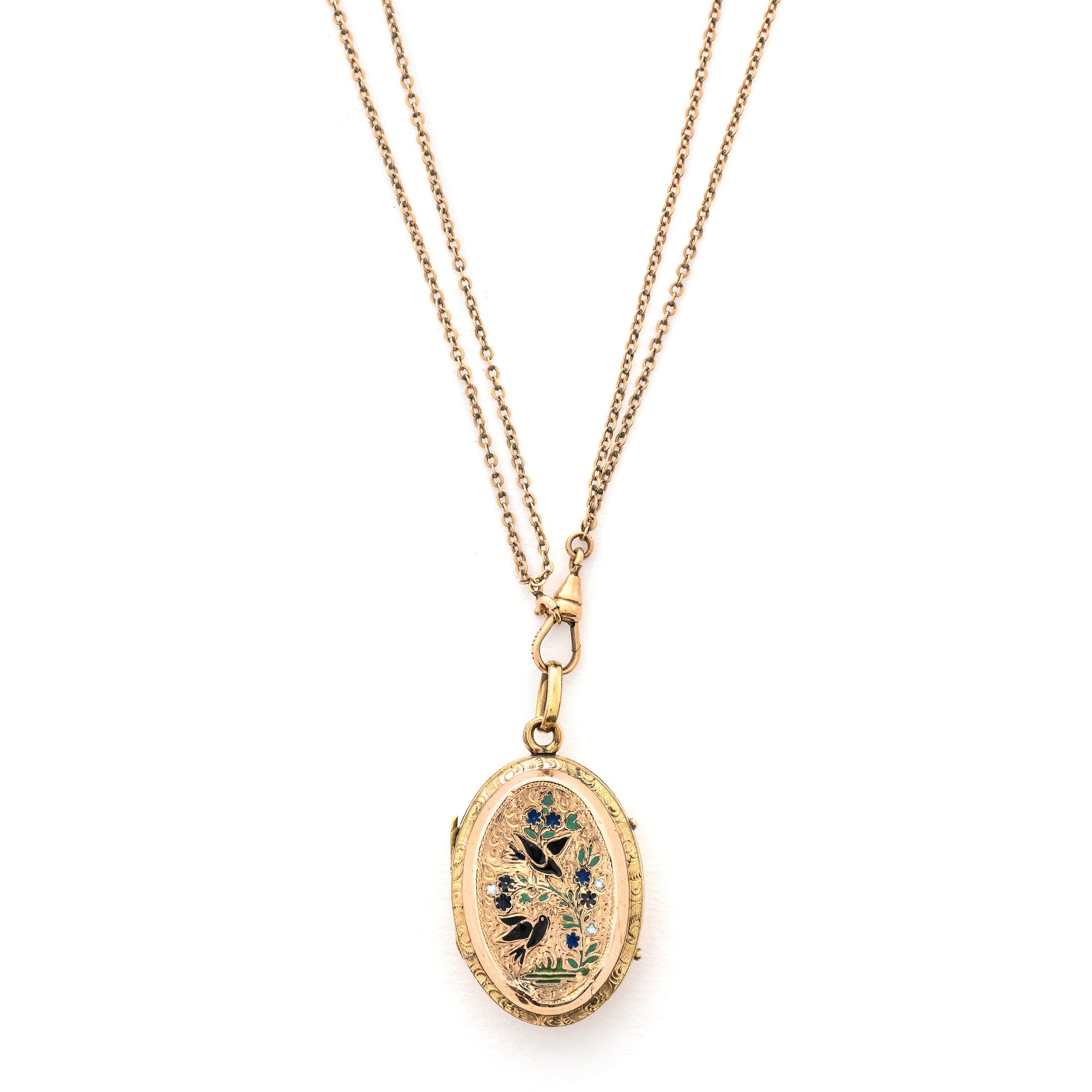 This striking oval locket features classic Victorian era symbolism with a pair of swallows surrounded by forget-me-not flowers enhanced with blue, white and green enamel throughout the design. It opens to hold two photos and pairs perfectly with one of our antique gold fill chains.  Front Locket View