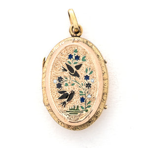 This striking oval locket features classic Victorian era symbolism with a pair of swallows surrounded by forget-me-not flowers enhanced with blue, white and green enamel throughout the design. It opens to hold two photos and pairs perfectly with one of our antique gold fill chains.  Front Locket View