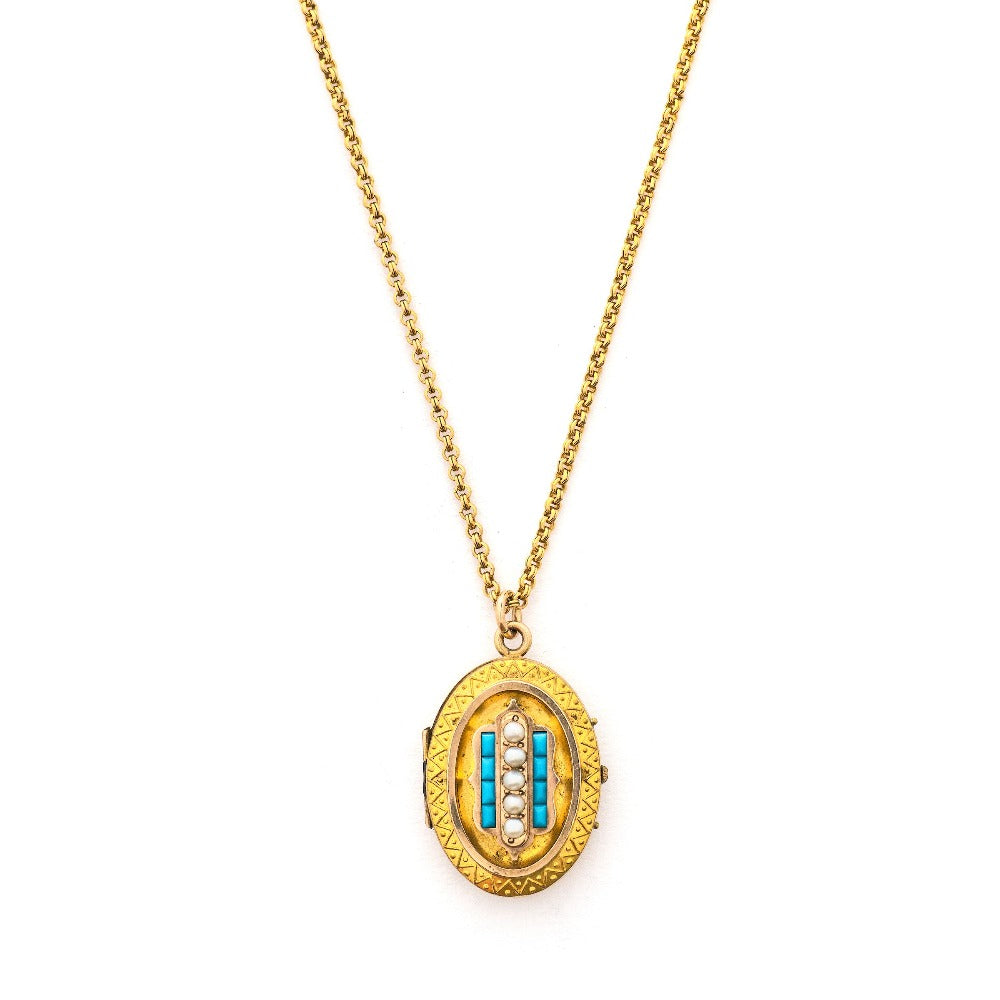 This oval locket features 5 pearls set above 8 turquoise baguettes with a zigzag pattern around the edge creating a dynamic three dimensional design. It opens to hold two photos, includes both original frames and pairs perfectly with one of our antique gold fill chains.  Front Locket View, shown on chain