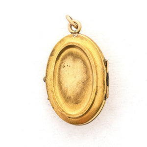 This oval locket features 5 pearls set above 8 turquoise baguettes with a zigzag pattern around the edge creating a dynamic three dimensional design. It opens to hold two photos, includes both original frames and pairs perfectly with one of our antique gold fill chains.  Back Locket View