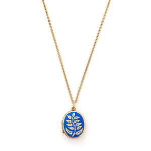This gorgeous oval locket features periwinkle blue enamel as the backdrop to a climbing golden vine. It opens to hold two photos and pairs perfectly with one of our antique gold fill chains. , front locket view, shown on chain