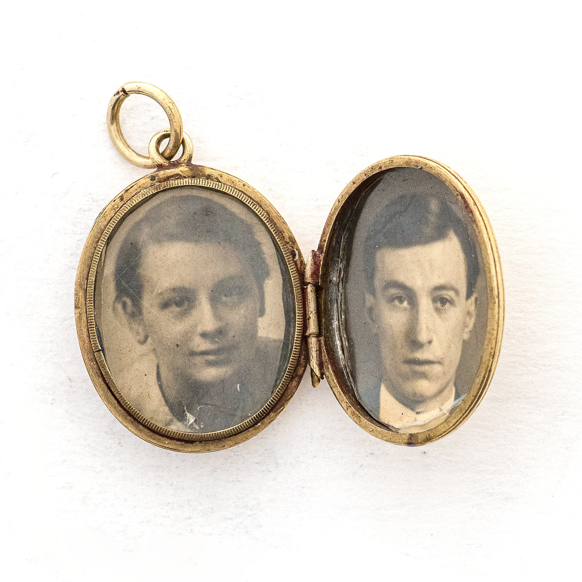 This gorgeous oval locket features periwinkle blue enamel as the backdrop to a climbing golden vine. It opens to hold two photos and pairs perfectly with one of our antique gold fill chains, open locket view