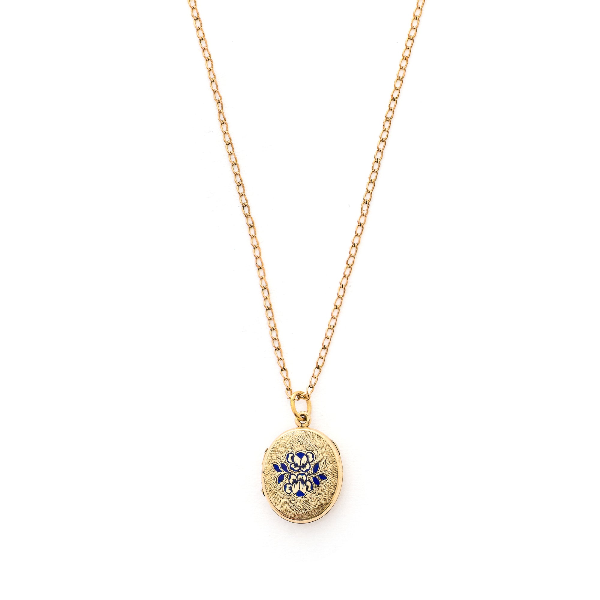 This sweet oval locket features a delicate rose design with navy blue enamel set on a finely textured background. The initials BBG are inscribed on the back. It opens to hold two photos, includes one original frame and glass and pairs perfectly with one of our antique gold fill chains.  Front locket view