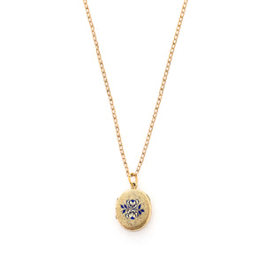 This sweet oval locket features a delicate rose design with navy blue enamel set on a finely textured background. The initials BBG are inscribed on the back. It opens to hold two photos, includes one original frame and glass and pairs perfectly with one of our antique gold fill chains.  Front locket view, shown on chain