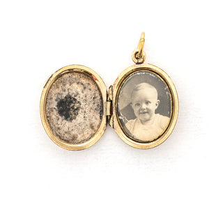 This sweet oval locket features a delicate rose design with navy blue enamel set on a finely textured background. The initials BBG are inscribed on the back. It opens to hold two photos, includes one original frame and glass and pairs perfectly with one of our antique gold fill chains.  Open locket View