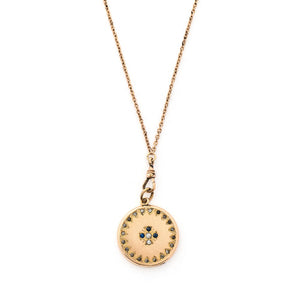 This round locket features a Maltese Cross, a symbol of protection, made up of blue, white and grey paste stones surrounded by a paste stone border. It opens to hold one photo and pairs perfectly with one of our antique gold fill chains.  Front locket view, shown on chain