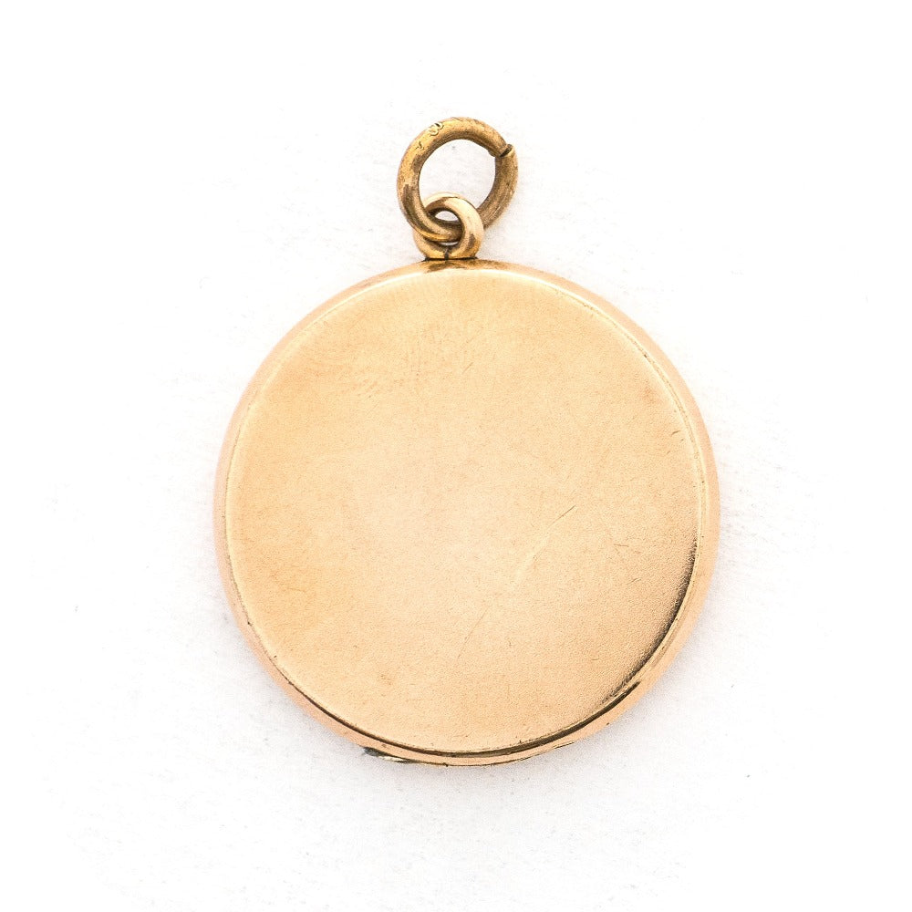 This round locket features a Maltese Cross, a symbol of protection, made up of blue, white and grey paste stones surrounded by a paste stone border. It opens to hold one photo and pairs perfectly with one of our antique gold fill chains.  Back locket view