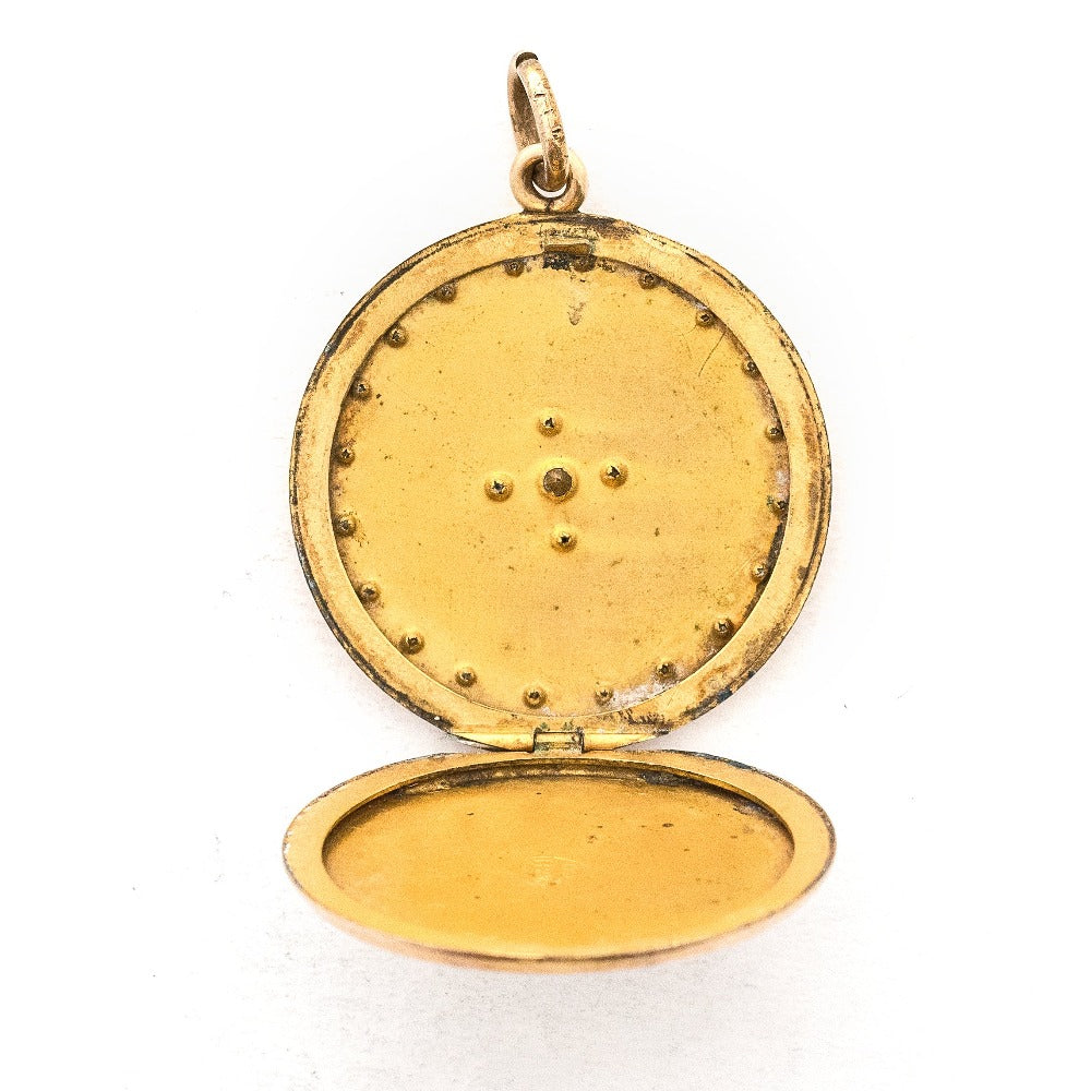 This round locket features a Maltese Cross, a symbol of protection, made up of blue, white and grey paste stones surrounded by a paste stone border. It opens to hold one photo and pairs perfectly with one of our antique gold fill chains.  Open locket view