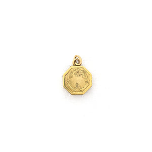This petite octagonal locket features a delicately etched floral motif including a classic Victorian era symbol, the forget-me-not flower at the top of the design. It opens to hold two (very tiny!) photos and pairs perfectly with one of our antique gold fill chains.  Front locket view