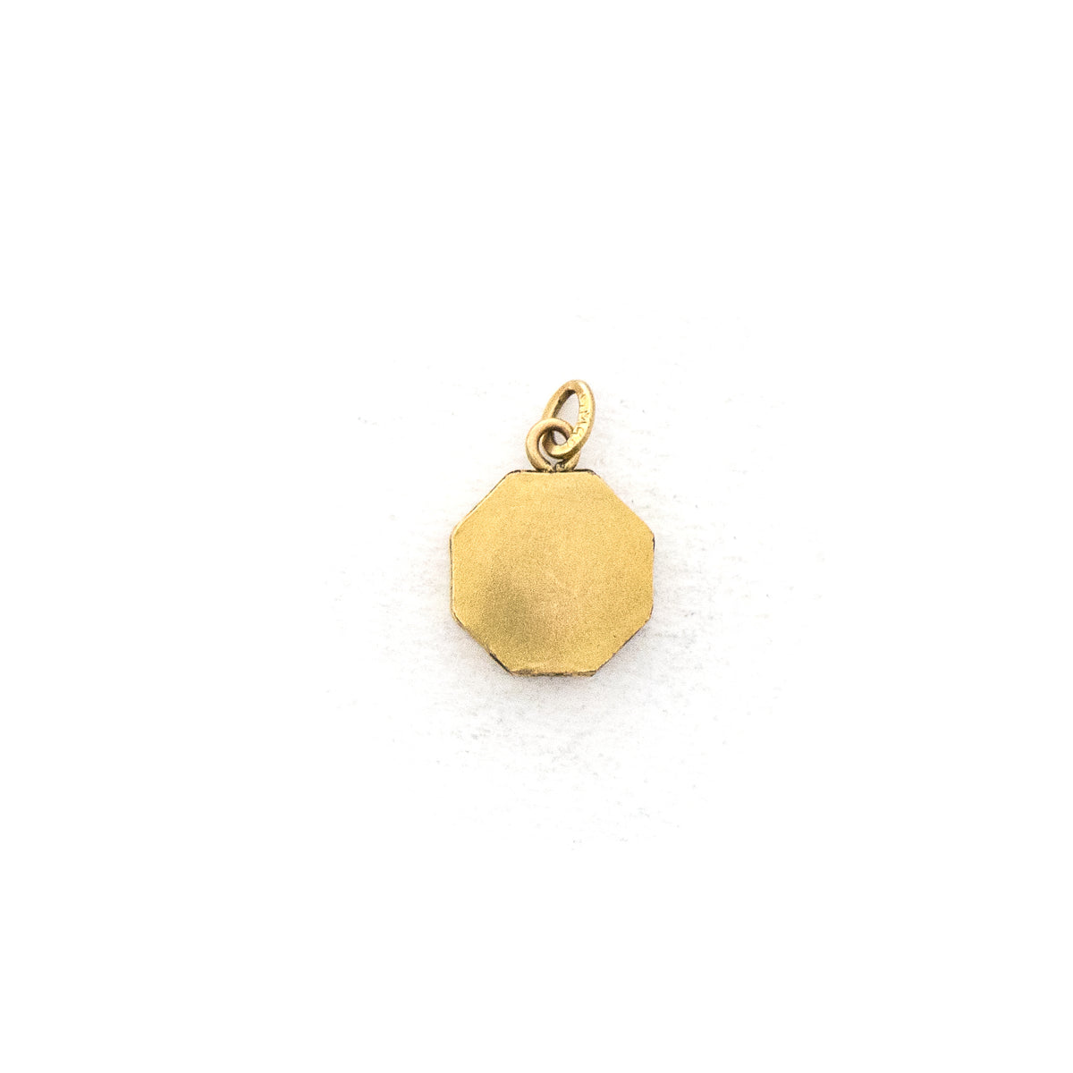 This petite octagonal locket features a delicately etched floral motif including a classic Victorian era symbol, the forget-me-not flower at the top of the design. It opens to hold two (very tiny!) photos and pairs perfectly with one of our antique gold fill chains.  Back Locket View