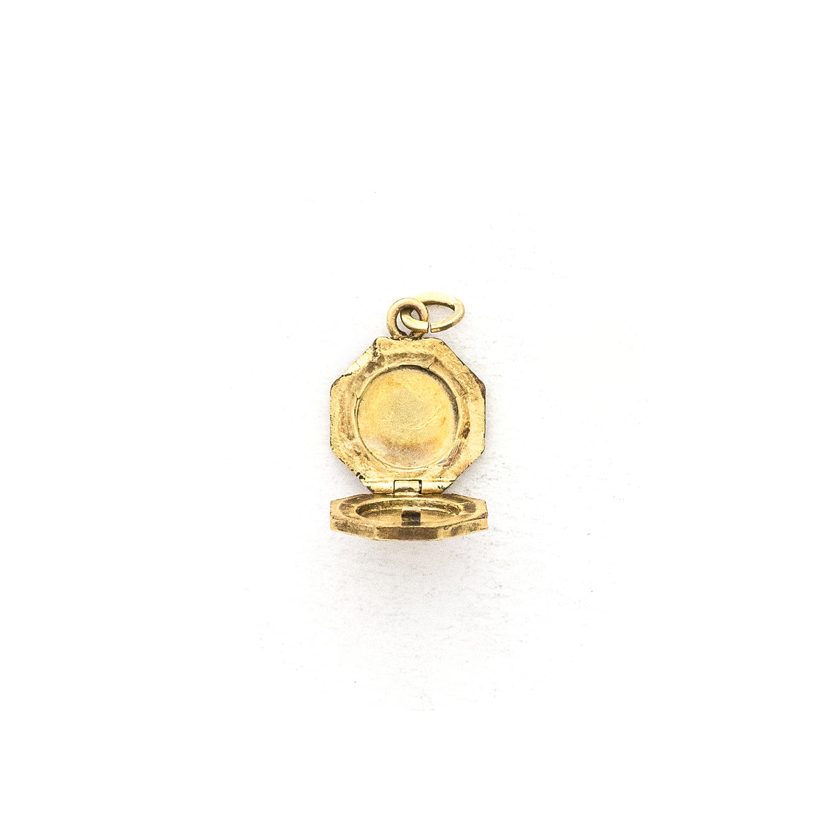 This petite octagonal locket features a delicately etched floral motif including a classic Victorian era symbol, the forget-me-not flower at the top of the design. It opens to hold two (very tiny!) photos and pairs perfectly with one of our antique gold fill chains.  Open Locket View