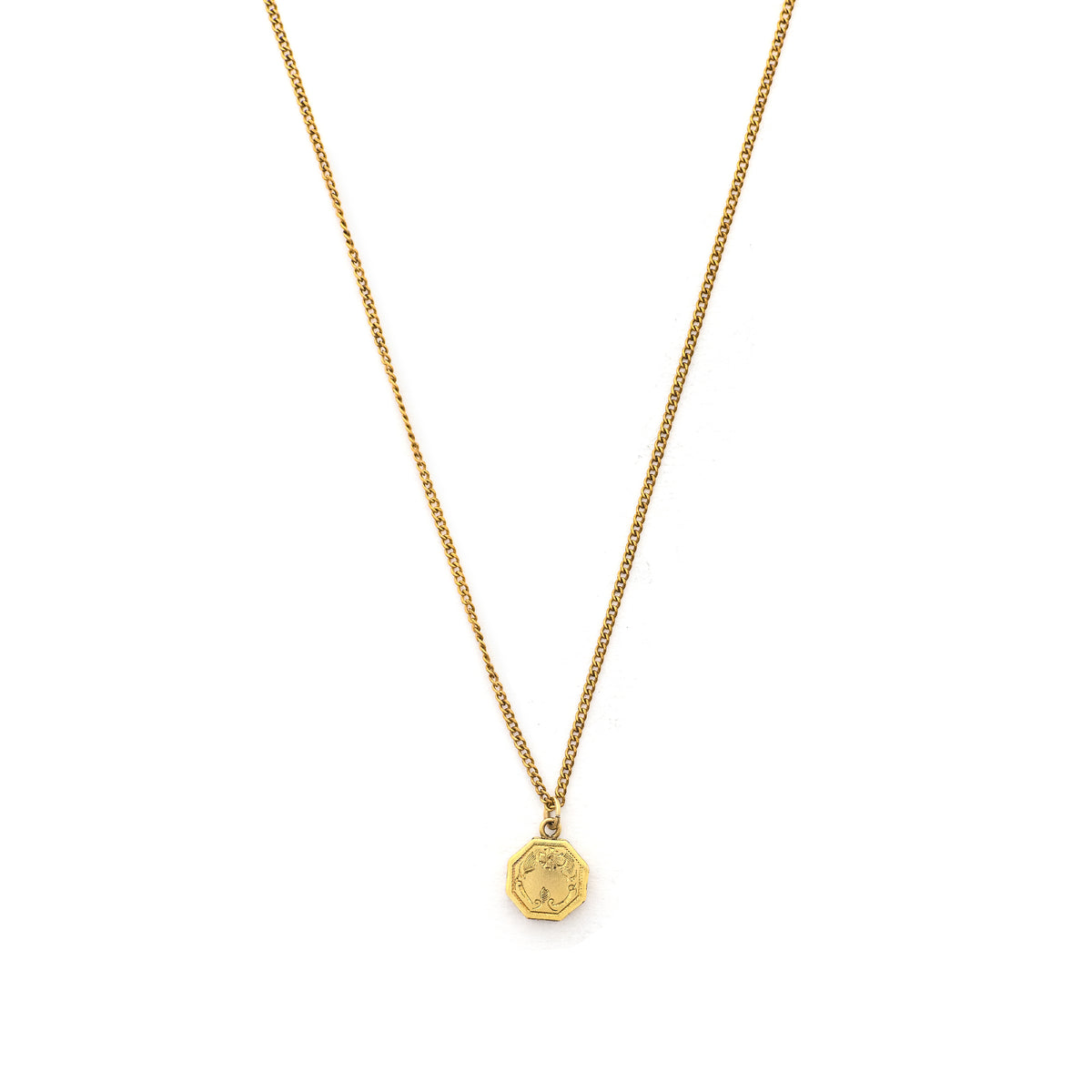 This petite octagonal locket features a delicately etched floral motif including a classic Victorian era symbol, the forget-me-not flower at the top of the design. It opens to hold two (very tiny!) photos and pairs perfectly with one of our antique gold fill chains.  Front locket view, shown on chain