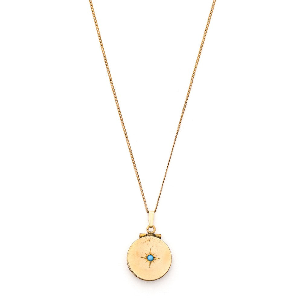 This petite circular locket features a classic Victorian starburst with a gorgeous opal at it's center. It opens to hold two photos and pairs perfectly with one of our antique gold fill chains.  Front Locket View