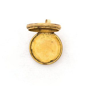 This petite circular locket features a classic Victorian starburst with a gorgeous opal at it's center. It opens to hold two photos and pairs perfectly with one of our antique gold fill chains.  Open Locket View