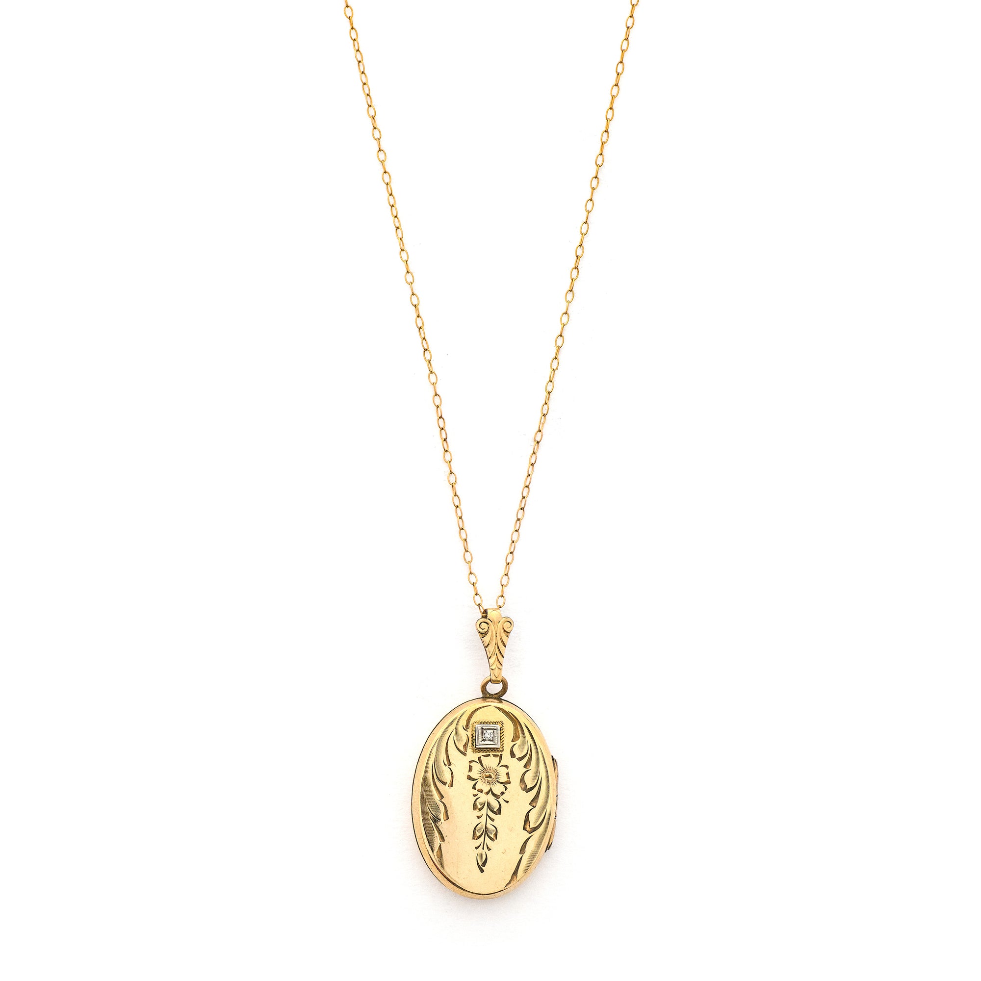 This oval locket features a genuine diamond atop a delicately etched forget-me-not flower with vines draped around it. It opens to hold two photos, includes both original frames and pairs perfectly with one of our antique gold fill chains. Front Locket View