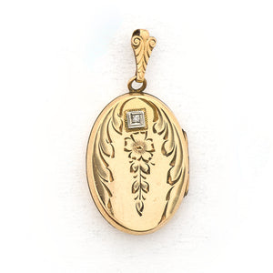 This oval locket features a genuine diamond atop a delicately etched forget-me-not flower with vines draped around it. It opens to hold two photos, includes both original frames and pairs perfectly with one of our antique gold fill chains. Front Locket View