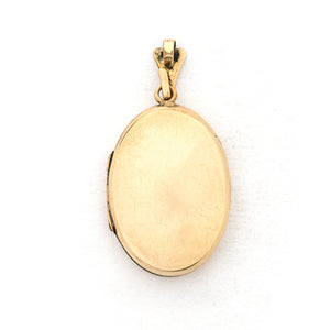 This oval locket features a genuine diamond atop a delicately etched forget-me-not flower with vines draped around it. It opens to hold two photos, includes both original frames and pairs perfectly with one of our antique gold fill chains. Back locket view