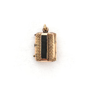 This petite rectangular locket features a basket weave pattern with a seed pearl on one side and a strip of black onyx on the other. It opens to hold two photos, includes both original frames and glass and pairs perfectly with one of our antique gold fill chains.  Back locket view